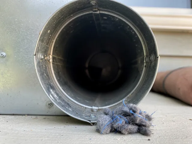 North Port Dryer Vent Cleaning technician using specialized equipment to clear severe dryer vent blockage in North Port